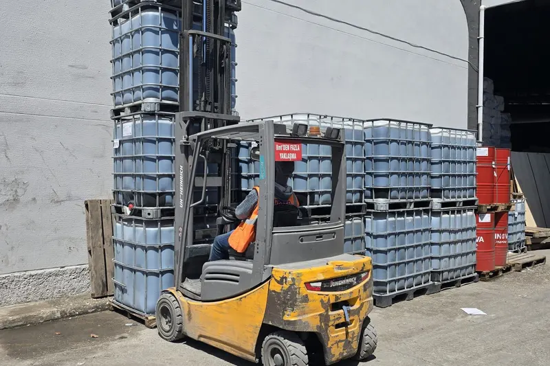 Forklift moving IBC totes in the yard at the Mersin hub