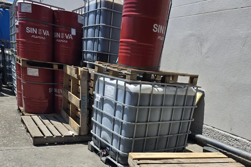 SINOVA Marine drums beside IBC totes on pallets in the Mersin hub yard